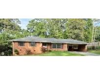 Quaint one-story brick home featuring mature trees and a convenient carport, offering comfort and style at 5535 Beaver Sw Dr, Mableton, GA 30126
