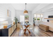 Cozy dining area with a glass table, white chairs, and a stylish wicker pendant light fixture at 1533 Park Brooke Sw Cir # 6, Marietta, GA 30008