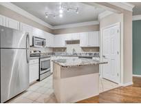 Well-lit kitchen featuring white cabinets, granite countertops, and stainless steel appliances at 1850 Cotillion Dr # 3305, Atlanta, GA 30338