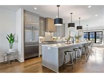 Modern kitchen with stainless steel appliances, quartz countertops, large island and pendant lighting at 726 Edgewood Ne Ave, Atlanta, GA 30307