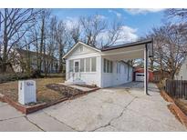 Charming white brick home with a covered carport and well-maintained landscaping at 556 Holly Nw St, Atlanta, GA 30318