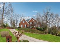 Charming brick home with well-manicured lawn, inviting curb appeal, and a long driveway at 3620 Highpoint Rd, Cumming, GA 30041