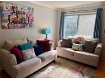Cozy living room with neutral walls and a large window providing natural light at 1225 Church St # N, Decatur, GA 30030