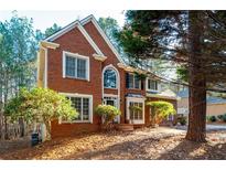 Charming two-story red brick home with manicured landscaping at 514 Lovinggood Ct, Woodstock, GA 30189