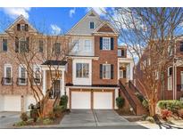 Beautiful brick townhome with two-car garage and front staircase, with a charming and well-maintained exterior at 5816 Riverstone Cir # 11, Atlanta, GA 30339