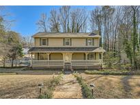 Charming two-story home with a welcoming front porch and well-maintained landscaping at 1634 Rex Dr, Marietta, GA 30066