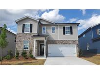 Charming two-story home with brick and siding, complemented by a well-manicured front yard at 7158 Brushwood Bend (110), Lithonia, GA 30058