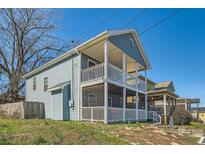 Charming two-story home with a double-decker porch and blue siding at 775 Welch Sw St, Atlanta, GA 30310