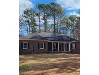 Charming single-story brick home with a covered porch and mature trees at 770 Prickett Rd, Douglasville, GA 30134
