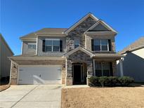 Charming two-story home with stone and siding facade, manicured lawn, and an attached two-car garage at 140 Craines Vw, Covington, GA 30014