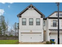 Modern two-story home with white siding, black trim, and a two-car garage at 43 N Auburn Landing Pl, Auburn, GA 30011