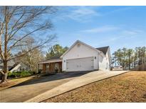 Charming home featuring a driveway and a well-maintained front lawn at 50 Berkshire Run, Covington, GA 30016