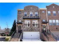 Charming brick townhome with inviting entrance and attached two-car garage at 3185 Quinn Pl, Atlanta, GA 30341