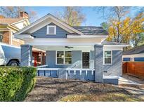 Charming bungalow featuring a covered front porch with white trim and a freshly landscaped yard at 944 Woodland Se Ave, Atlanta, GA 30316