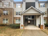 A charming apartment complex showcasing a mix of brick and siding facade with welcoming entrance and staircase at 18201 Waldrop Cv, Decatur, GA 30034