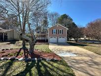Charming two-story home with a front-facing two-car garage and a cozy front porch at 101 Summer Pond Trl, Lawrenceville, GA 30046