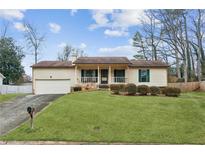 Charming single Gathering home with well-maintained lawn and attached garage at 5176 Downs Way, Norcross, GA 30093