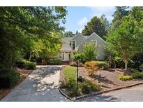 Charming exterior of a well-maintained home with lush landscaping and a welcoming driveway at 857 Stovall Ne Pl, Atlanta, GA 30342
