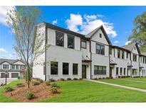Charming new construction townhome with brick and siding exterior, green lawn and beautiful landscaping at 1330 Parc Bench Rd, Atlanta, GA 30316