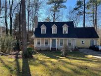 Charming home featuring dormer windows, chimney, and well-maintained front lawn at 944 Pine Ridge Dr, Stone Mountain, GA 30087