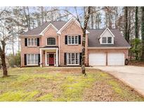 Charming brick home with a manicured lawn, black shutters and attached two-car garage at 5485 Brookstone Nw Dr, Acworth, GA 30101