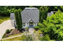 Stunning home with modern architectural design surrounded by mature trees and lush landscaping at 11260 Houze Rd, Roswell, GA 30076