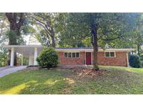 Charming brick home with a well-maintained lawn and covered carport at 2764 Riggs Dr, Atlanta, GA 30344