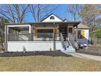 Charming renovated home featuring a covered front porch, fresh paint, and landscaped yard at 384 Carey Dr, Atlanta, GA 30315