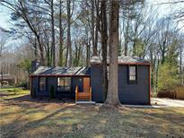 Charming home with updated exterior, front lawn, and inviting wood-stained entryway at 1154 Stone Mill Run, Lawrenceville, GA 30046