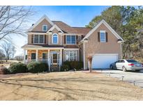 Beautiful two-story home with a manicured lawn, two car garage, and stone accents near the front porch at 190 Country Club Dr, Hiram, GA 30141
