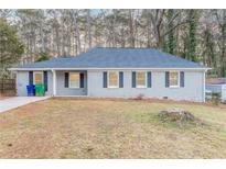 Charming single-story home featuring brick accents, a well-maintained lawn, and a classic exterior design at 2303 Pinewood Dr, Decatur, GA 30032