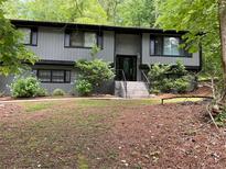 Charming home featuring a well-maintained front yard with mature trees and a welcoming entrance at 3630 High Point Sw Ln, Atlanta, GA 30331