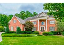 Charming two-story brick home with a meticulously manicured front lawn, enhanced by mature trees at 6205 Arnall Nw Ct, Acworth, GA 30101