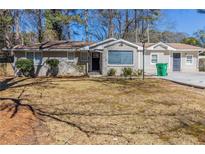 Charming single-story home with a brick facade, well-maintained landscaping, and a welcoming entrance at 3716 Loren Dr, Decatur, GA 30032