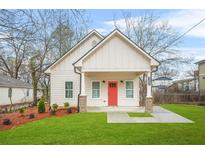 Charming exterior view of a modern home with a red door and well-maintained lawn at 395 W Lake Nw Ave, Atlanta, GA 30318