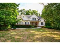 Charming home with a manicured front yard and mature trees offering great curb appeal at 160 Edgewater Trl, Fayetteville, GA 30215