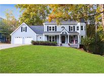 Charming two-story home with a well-manicured lawn, two-car garage, and welcoming front porch at 1421 Eryn Cir, Suwanee, GA 30024