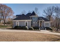 Charming home with stone accents, mature landscaping, and a circular driveway at 4610 Riversound Drive, Snellville, GA 30039