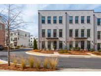 Modern townhome exterior showing the brick facade, black windows, and landscaped front yard at 472 Burton Dr, Alpharetta, GA 30009