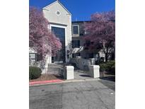 Inviting condo building entrance framed by beautiful blooming trees at 4106 Pine Heights Ne Dr, Atlanta, GA 30324