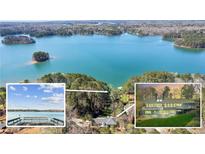 Expansive aerial view of a lakeside property featuring a house, private dock, and serene lake surrounded by lush trees at 6475 Holland Dr, Cumming, GA 30041