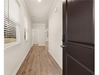 Inviting entryway featuring wood-look floors and ample natural light from the windows at 1084 Georgian Point Dr, Lawrenceville, GA 30045