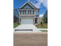 Charming two-story home with a spacious two-car garage and well-manicured lawn at 1084 Georgian Point Dr, Lawrenceville, GA 30045