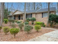 Charming brick home with manicured landscaping, a welcoming porch, and a cozy residential feel at 8980 Country Club Dr, Douglasville, GA 30134