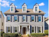 Charming home featuring gray shingles, black shutters, dormer windows, and a beautifully landscaped front yard at 2949 Gateland Sq, Marietta, GA 30062
