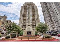 Beautiful exterior view of Park Towers, a luxury high-rise featuring a circular driveway and manicured landscaping at 795 Hammond Dr # 709, Atlanta, GA 30328