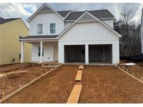 Charming two-story home with a two-car garage and unfinished front yard at 124 Bloomfield Cir, Canton, GA 30114