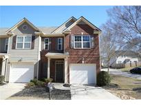Charming townhome with brick and siding, featuring a one-car garage and well-maintained landscaping at 3374 Thornbridge Dr, Powder Springs, GA 30127
