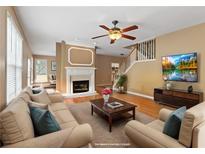 Bright living room with hardwood floors, a fireplace, and a comfortable seating area at 2810 Stillwater Park Dr, Marietta, GA 30066