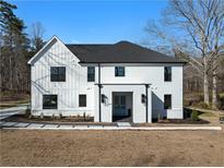 Charming two-story home with modern farmhouse design, black accents, manicured landscaping, and inviting entry at 5760 Pearson Rd, Powder Springs, GA 30127